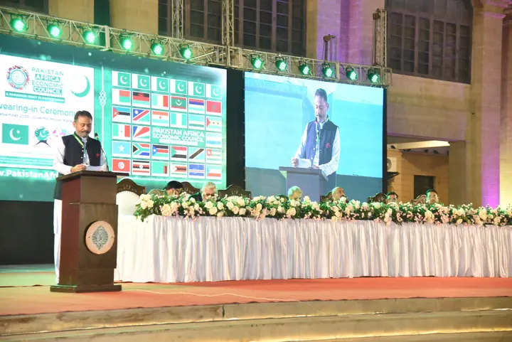 A PAEC representative addressing members and guests from the main stage.